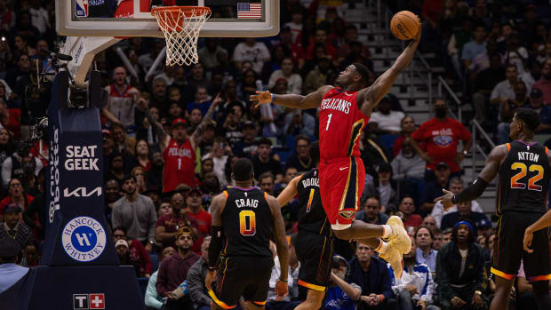 Dec 9, 2022; New Orleans, Louisiana, USA; New Orleans Pelicans forward Zion Williamson (1) dunks the ball against Phoenix Suns guard Devin Booker (1) and forward Torrey Craig (0) during the second half at Smoothie King Center.